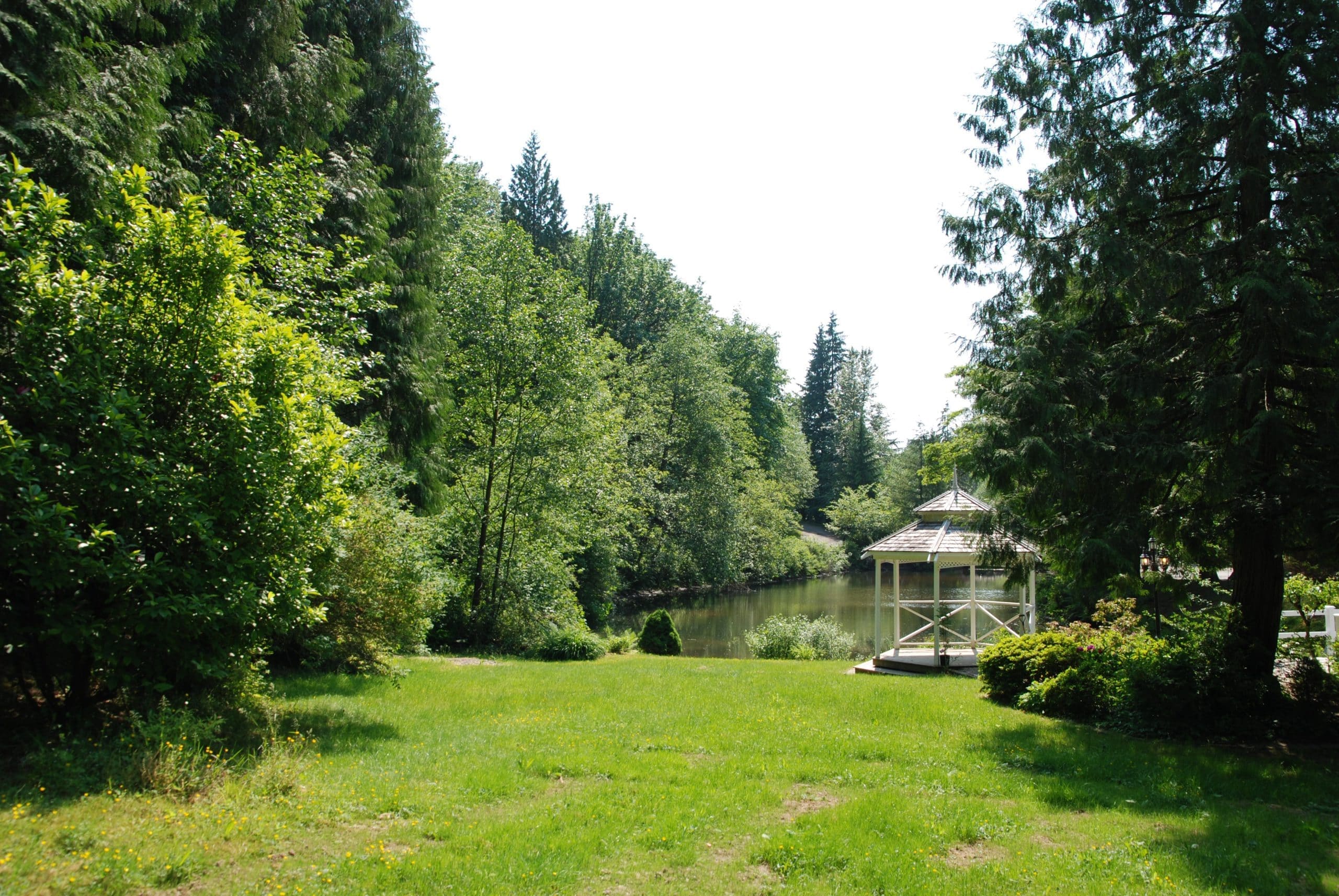 White gazebo overlooking the resort pond surrounded by gardens