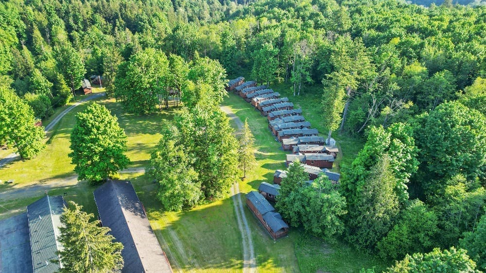 Aerial view of the deluxe cabins nestled along the treeline