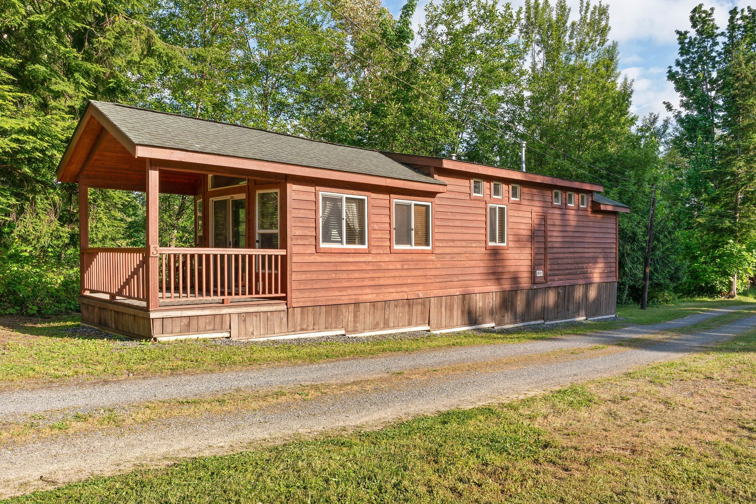 Red cedar deluxe cabin exterior with covered porch